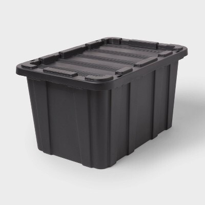 Black storage bins with snap- on lids for organizing Christmas decorations