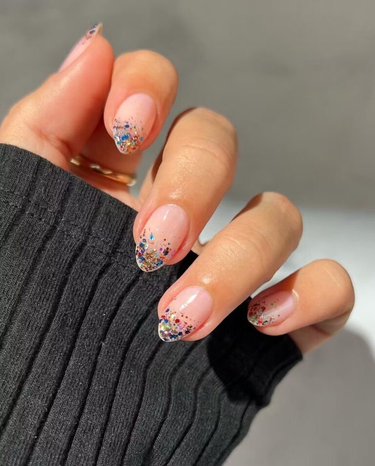 Short nude nails with multicolor confetti glitter concentrated at the tips