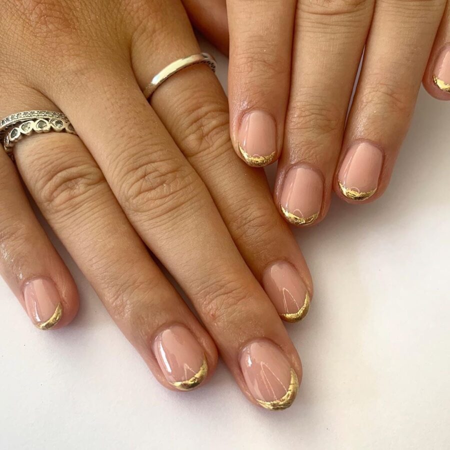 Champagne nude nails with gold foil on the tips