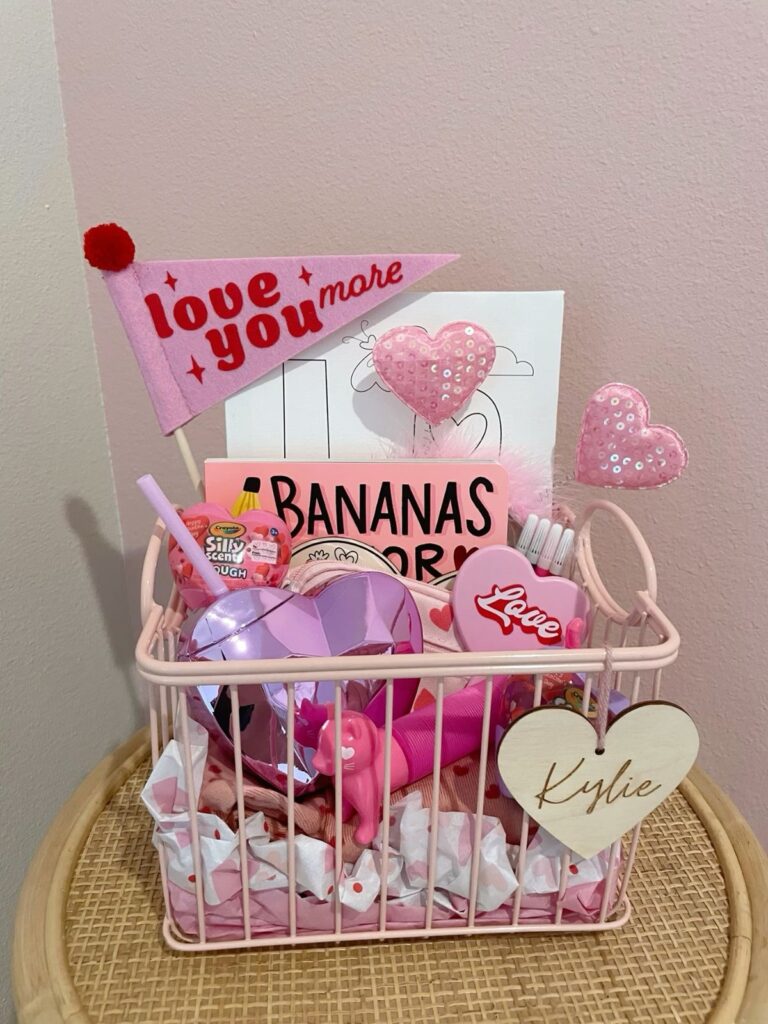 Bright pink Valentine’s basket filled with pink toys, snacks, and cozy pink accessories for kids.