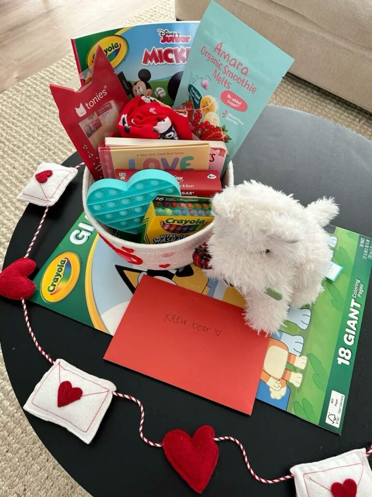 Crayola creativity Valentine’s basket with crayons, markers, coloring books, and art supplies.